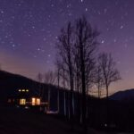 View of house with starry night sky.