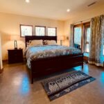A king size bed, heated floors and en-suite bathroom await you in the master bedroom. The lower screened porch with double sliding doors is just a step away.