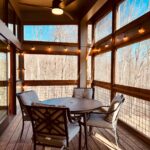 Your upper screened porch is accessible by two separate doors - one from the kitchen/dining room and one from the living room.